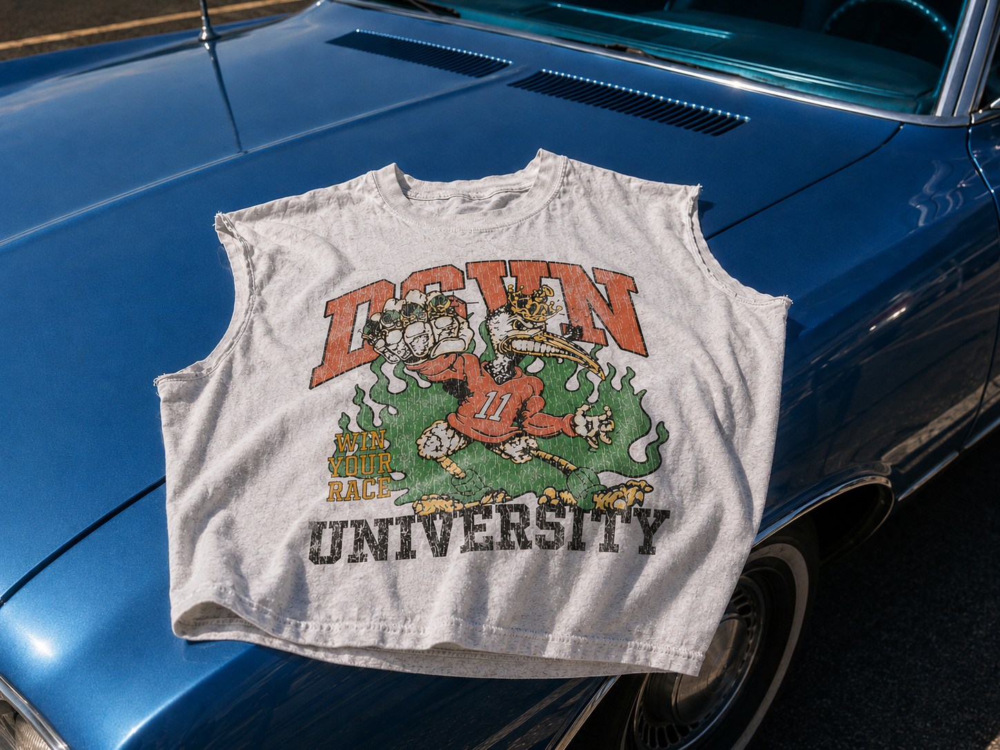 Vintage-style sleeveless shirt with graphic design on a blue car hood